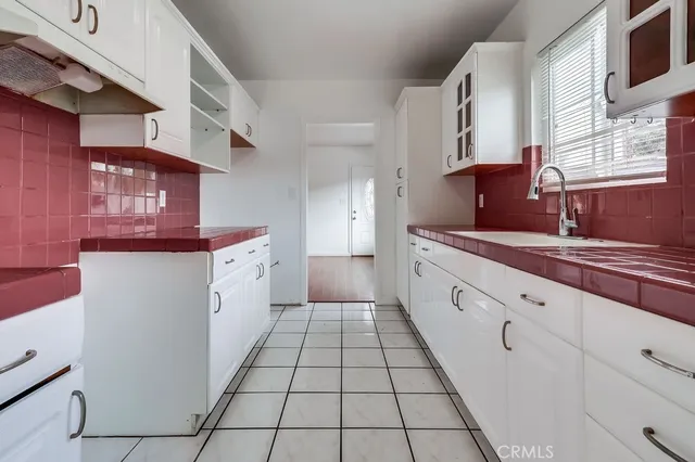 a large white kitchen with cabinets