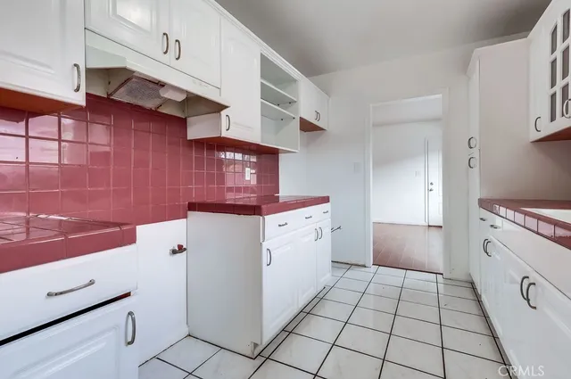a utility room with cabinets washer and dryer