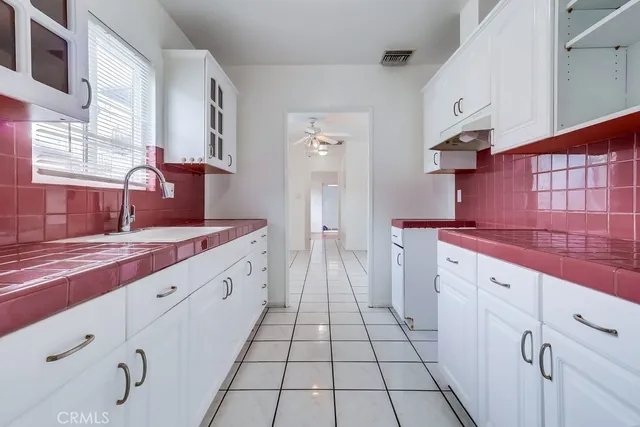 a spacious bathroom with a sink and a mirror