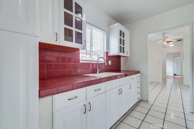 a kitchen with cabinets and window