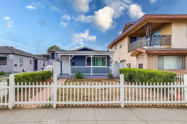 a front view of house with wooden fence