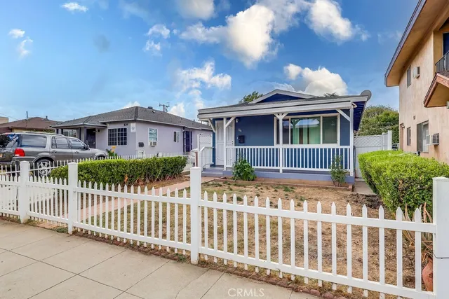 a view of a house with wooden fence