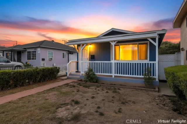 a view of a house with a yard and deck