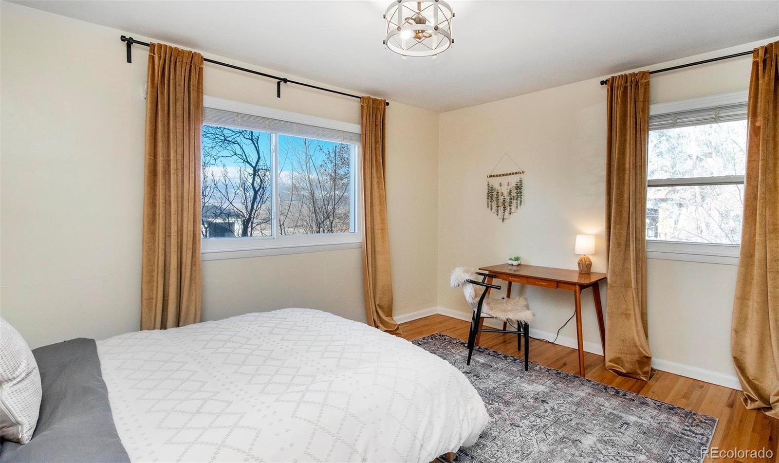 6480 Garrison Street Arvada, CO 80004 - Photo 19 of 40 a bedroom with a bed and a window