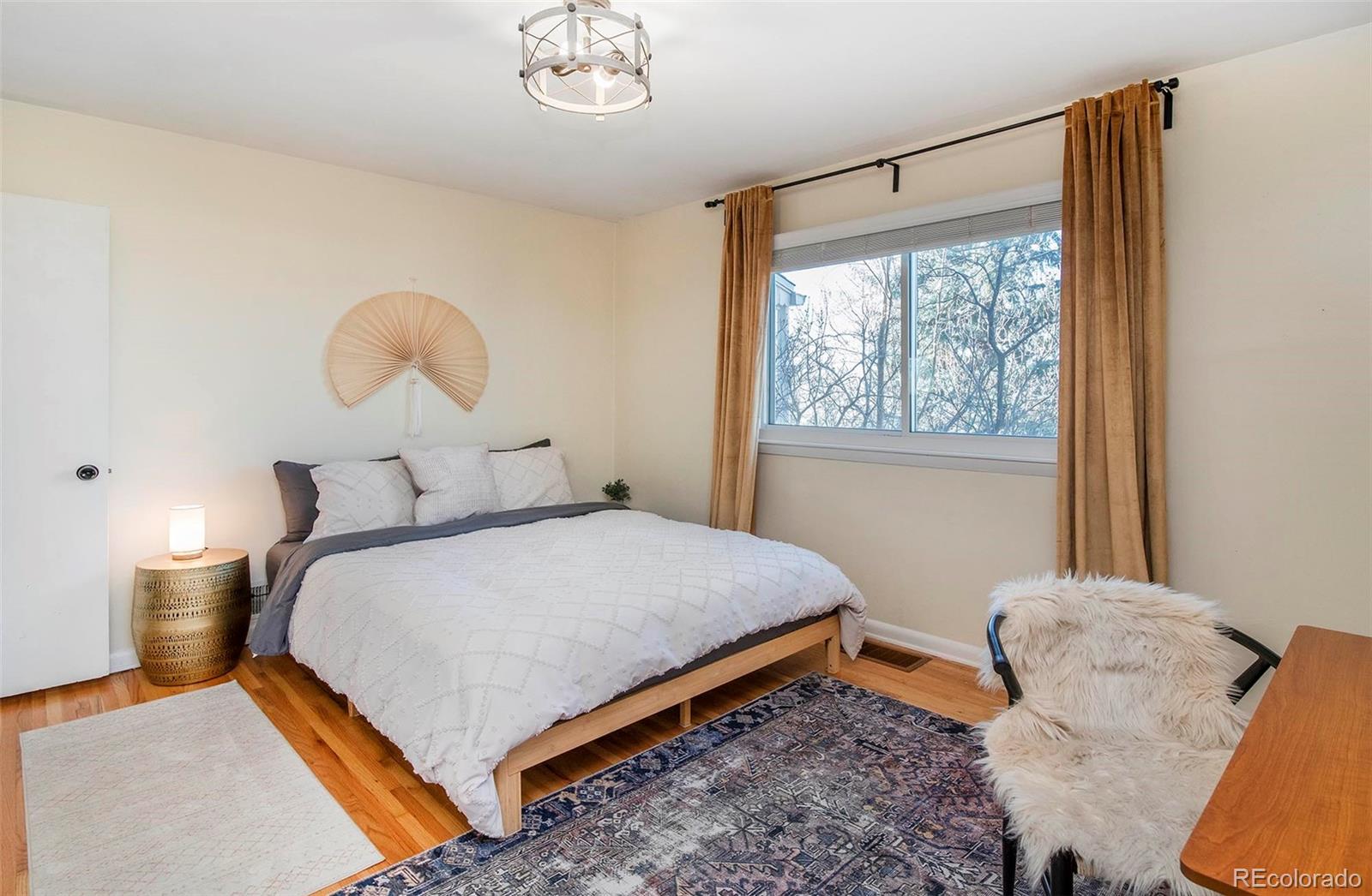 6480 Garrison Street Arvada, CO 80004 - Photo 20 of 40 a bedroom with a bed and window with lamp