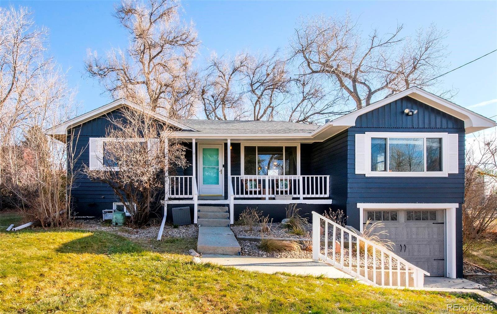 6480 Garrison Street Arvada, CO 80004 - Photo 2 of 40 a front view of a house with swimming pool