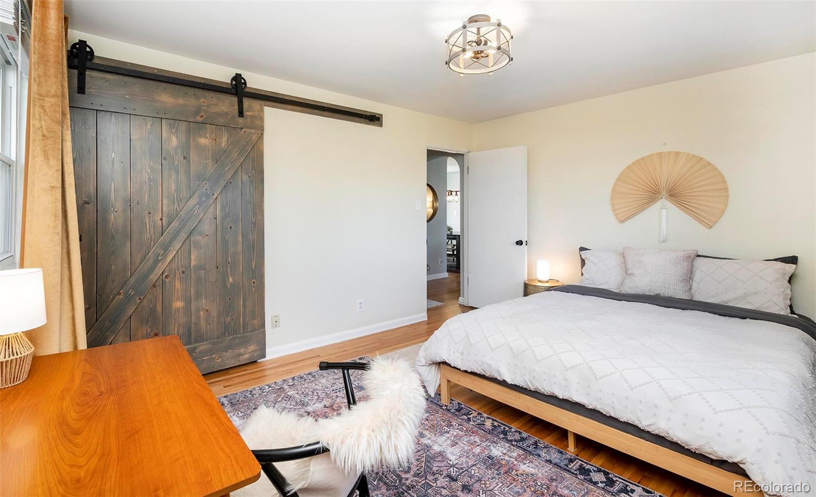 6480 Garrison Street Arvada, CO 80004 - Photo 21 of 40 a bedroom with a bed and a chandelier