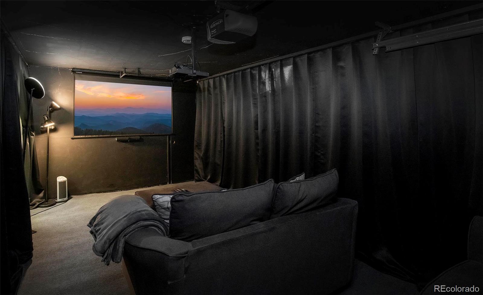 6480 Garrison Street Arvada, CO 80004 - Photo 30 of 40 a living room with furniture and a flat screen tv