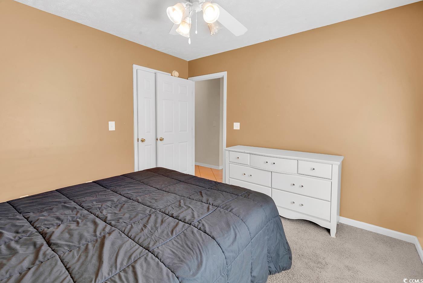 246 Catawba River Road Myrtle Beach, SC 29588 - Photo 11 of 27 Bedroom featuring light colored carpet and a ceiling fan