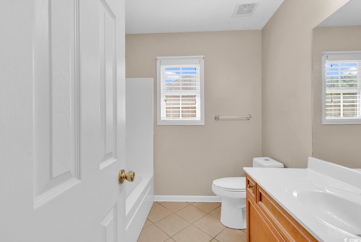 246 Catawba River Road Myrtle Beach, SC 29588 - Photo 12 of 27 Full bath with vanity, light tile patterned floors, and bathtub / shower combination