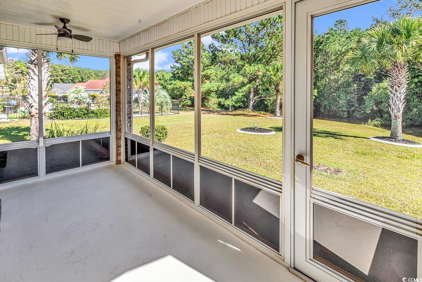246 Catawba River Road Myrtle Beach, SC 29588 - Photo 23 of 27 Unfurnished sunroom featuring ceiling fan and view of scattered trees