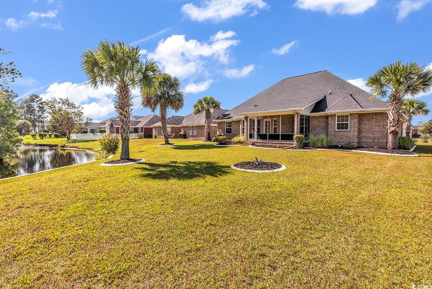 246 Catawba River Road Myrtle Beach, SC 29588 - Photo 26 of 27 View of green lawn featuring a water view