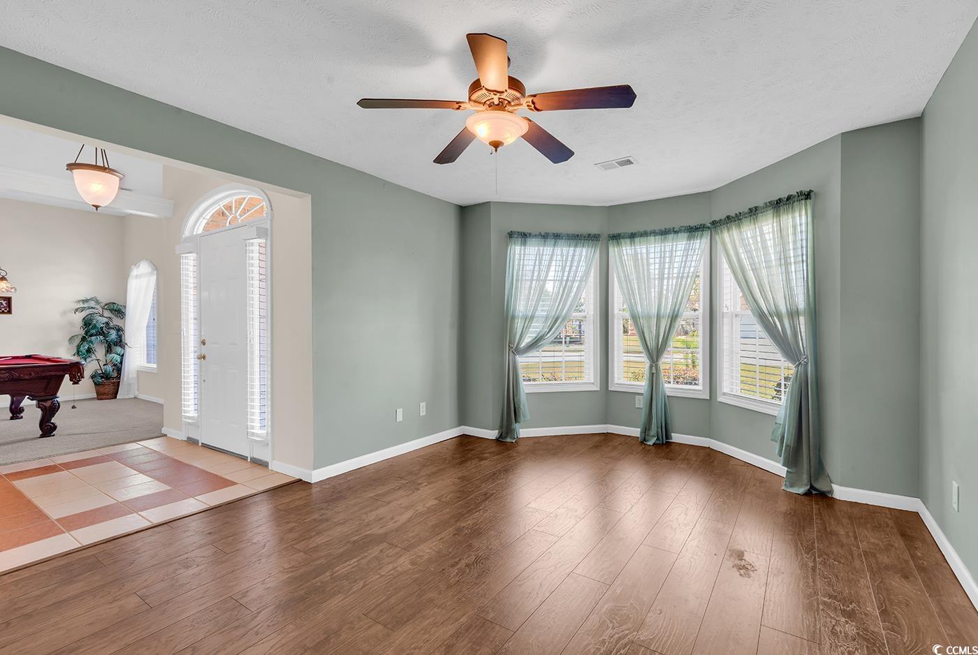 Empty room featuring ceiling fan, and wood finished floors