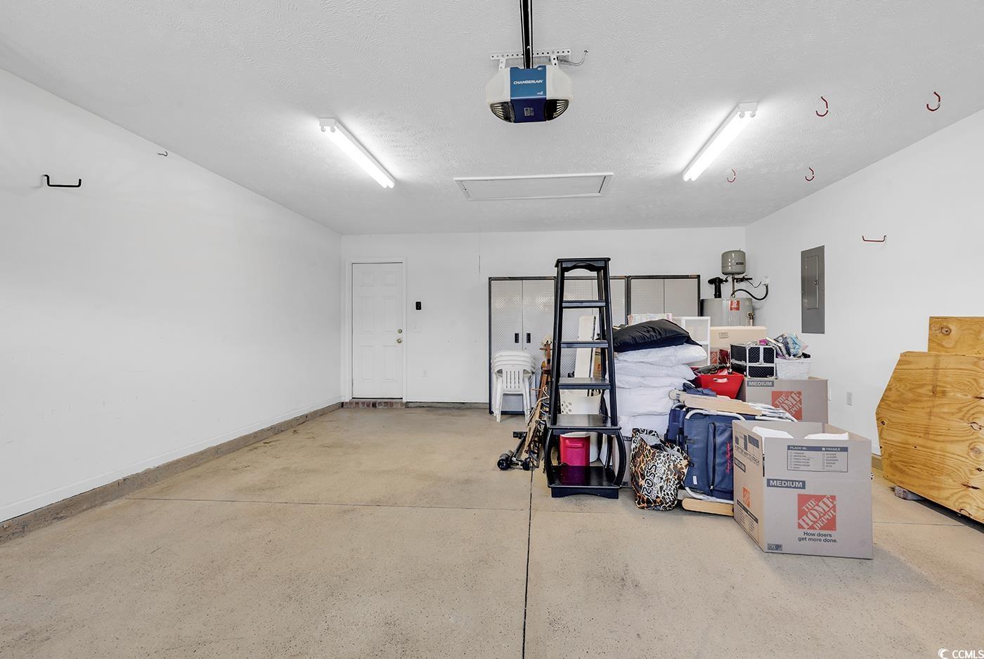 246 Catawba River Road Myrtle Beach, SC 29588 - Photo 10 of 27 Garage with electric panel and a garage door opener