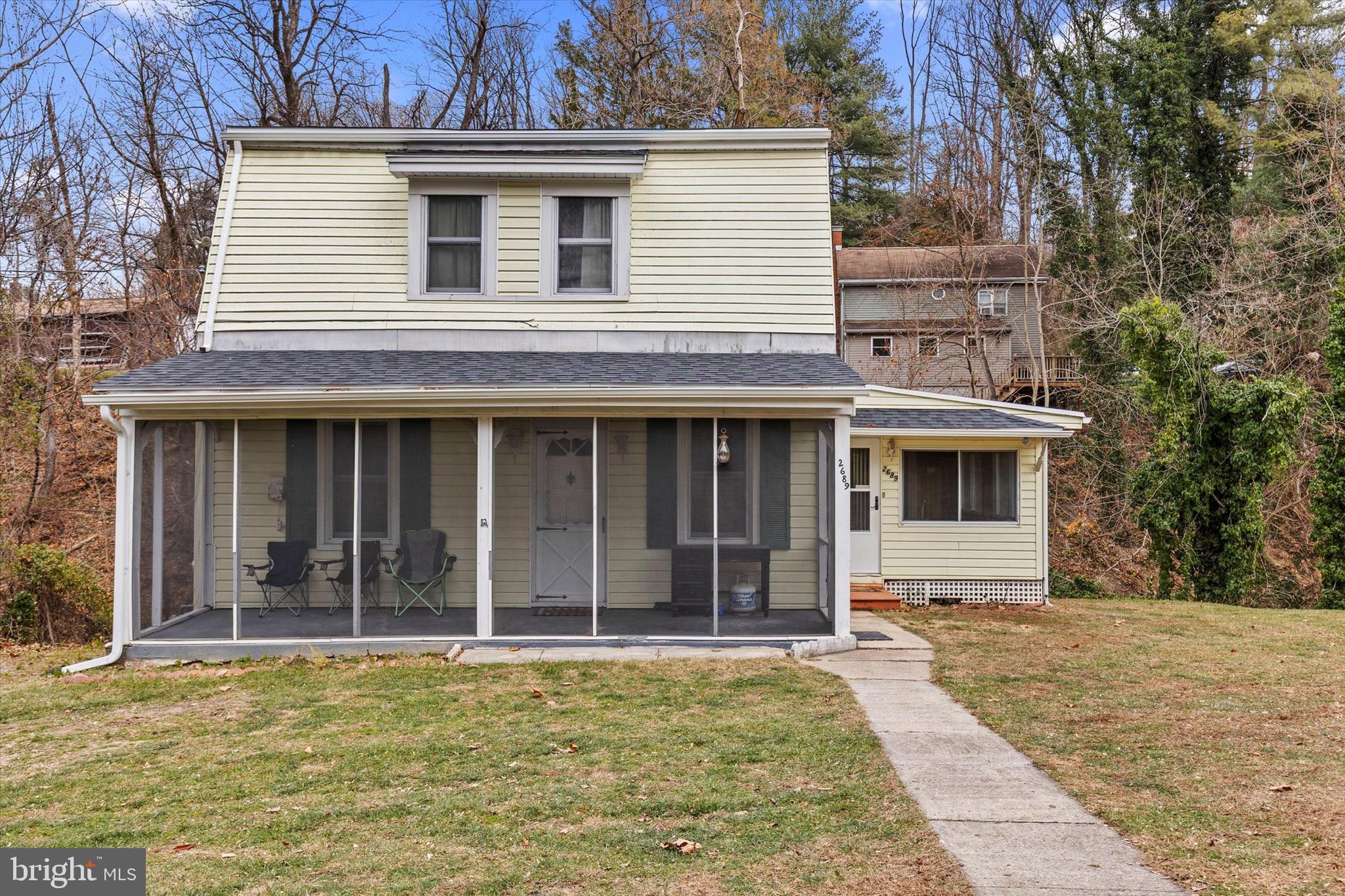 2689 Sheridan Road York, PA 17406 - Photo 3 of 28 a view of a white house with large windows and a small yard