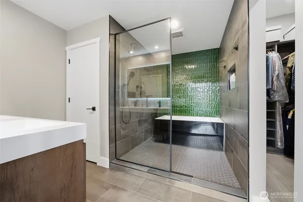 a bathroom with a glass shower door