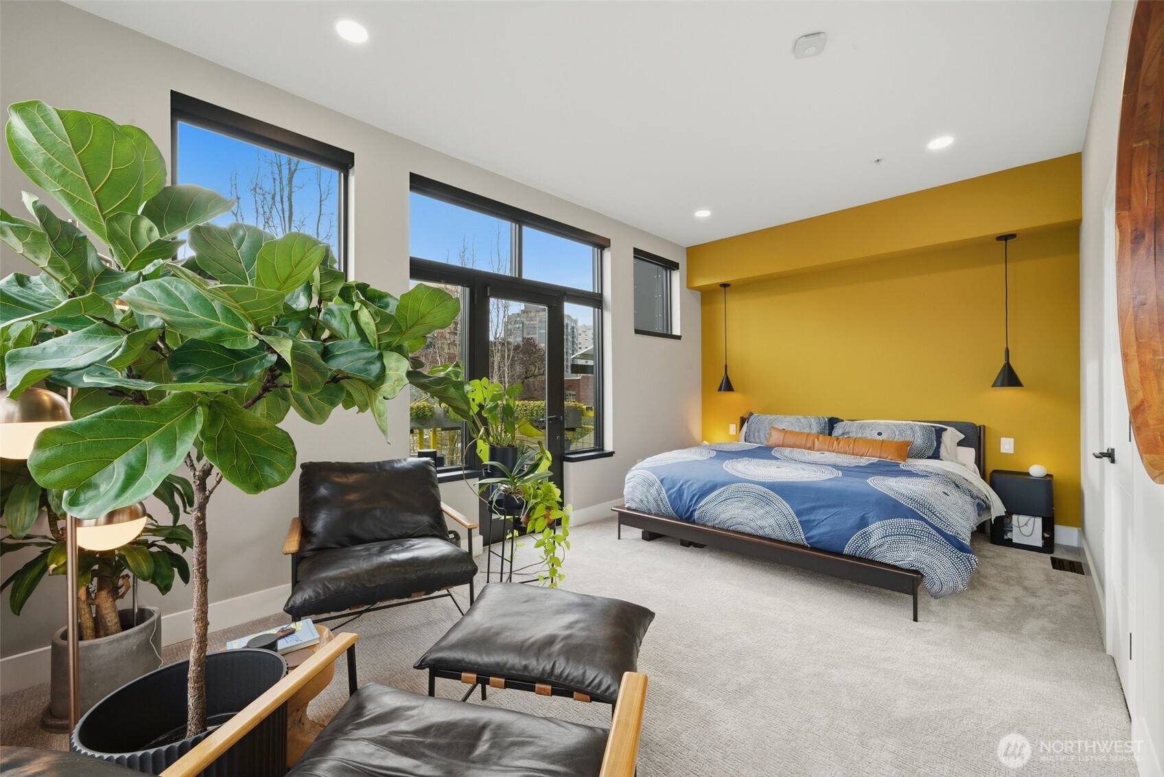 615 East Pike Street, Unit 402 Seattle, WA 98122 - Photo 10 of 31 a bedroom with a bed potted plant with the floor to ceiling window and wooden floor