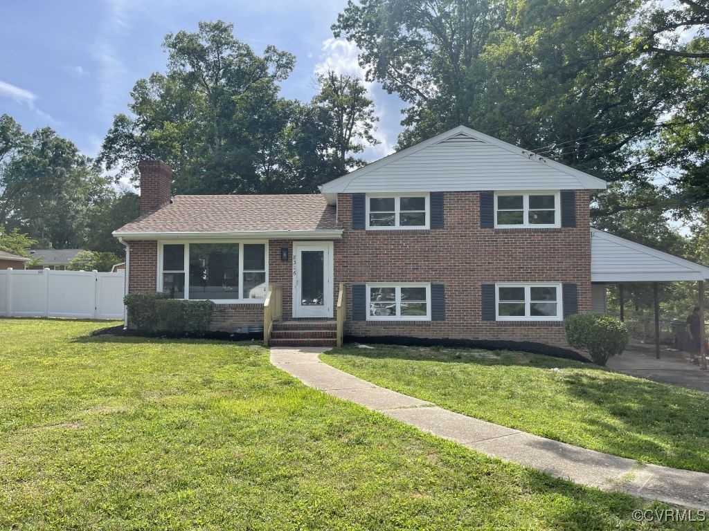 8306 Dade Road Richmond, VA 23227 - Photo 1 of 21 Split level home featuring brick siding and a chim