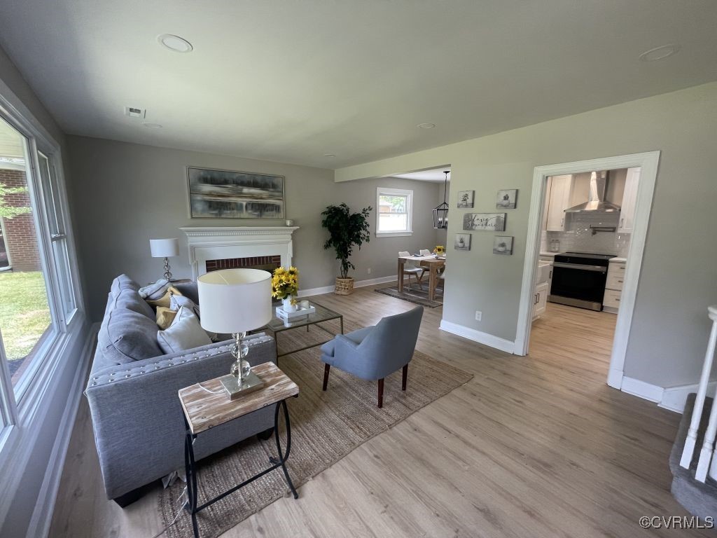 8306 Dade Road Richmond, VA 23227 - Photo 2 of 21 Living area with a fireplace and wood finished flo