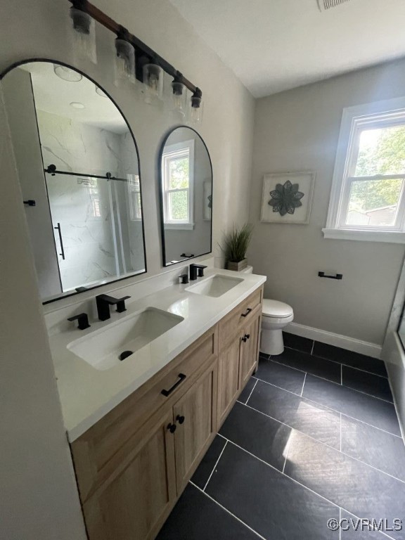 8306 Dade Road Richmond, VA 23227 - Photo 8 of 21 Bathroom with double vanity, a marble finish showe