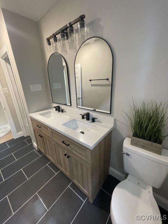 8306 Dade Road Richmond, VA 23227 - Photo 10 of 21 Bathroom featuring double vanity and tile patterne