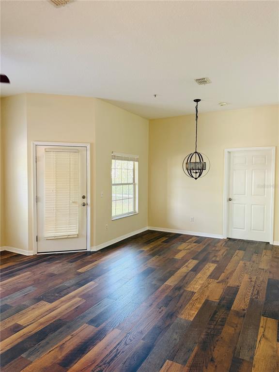 970 North Spring Garden Avenue, Unit 311 DeLand, FL 32720 - Photo 8 of 16 a view of empty room with wooden floor and fan