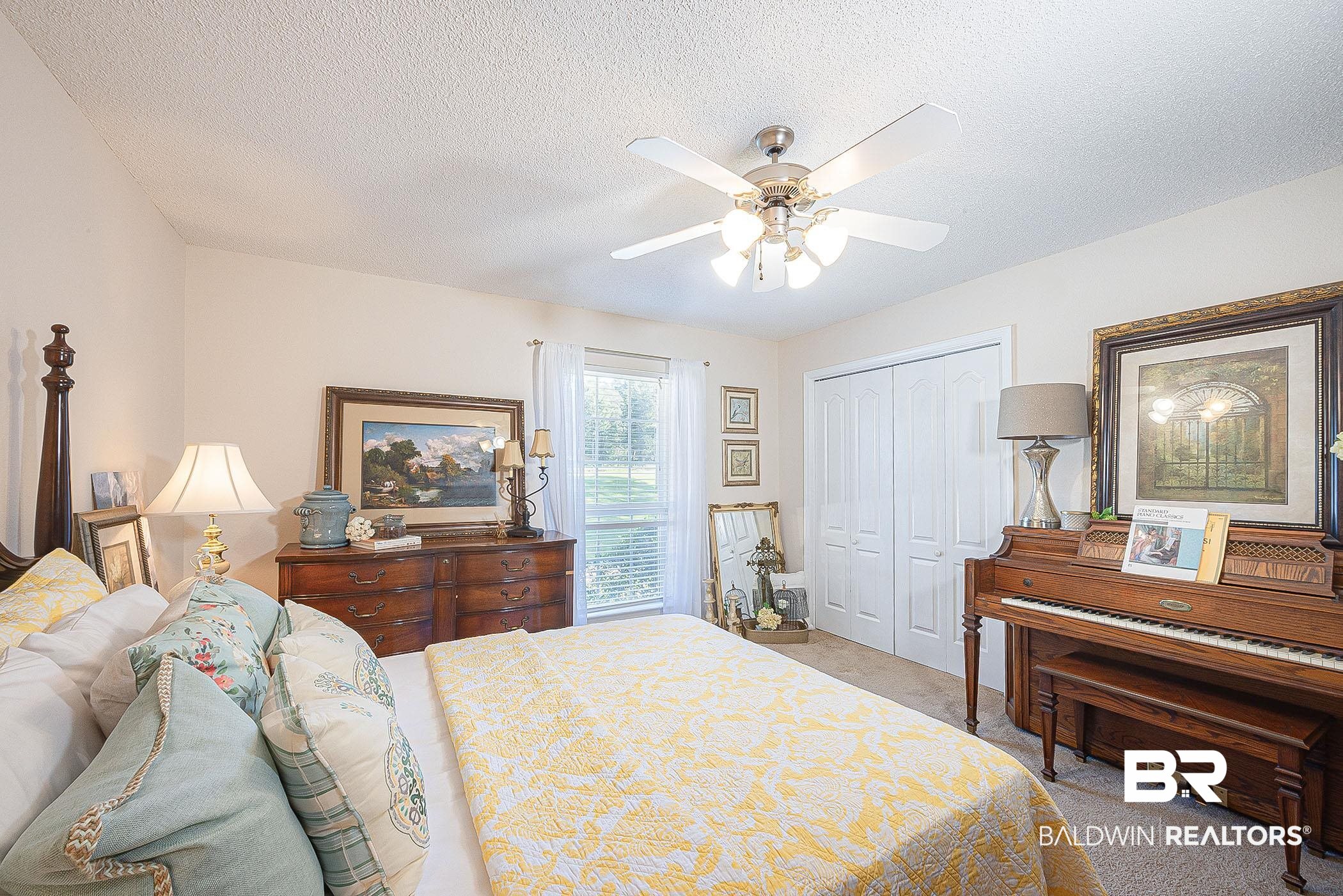 12230 Bromley Road Stapleton, AL 36578 - Photo 24 of 34 Bedroom featuring light carpet, a closet, a textured ceiling, and a ceiling fan