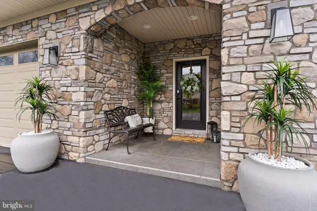 a view of a dining room and livingroom with furniture wooden floor a chandelier