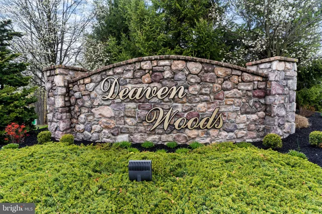 a kitchen with stainless steel appliances granite countertop a table chairs stove and refrigerator