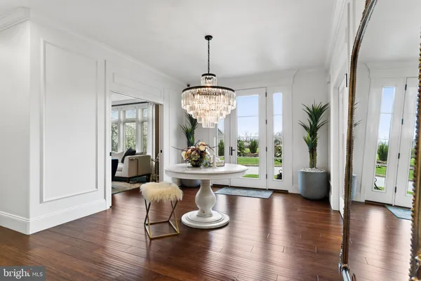 a view of a hallway with the view of living room and entryway