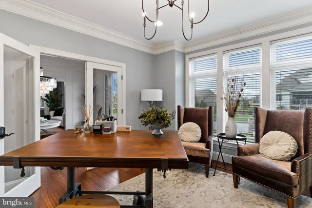a bedroom with a large bed and a chandelier fan