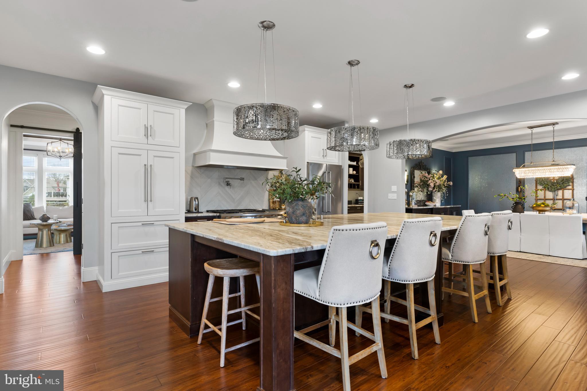 6522 Plowman Ridge Harrisburg, PA 17112 - Photo 43 of 117 a kitchen with stainless steel appliances kitchen island granite countertop a dining table chairs and wooden floor