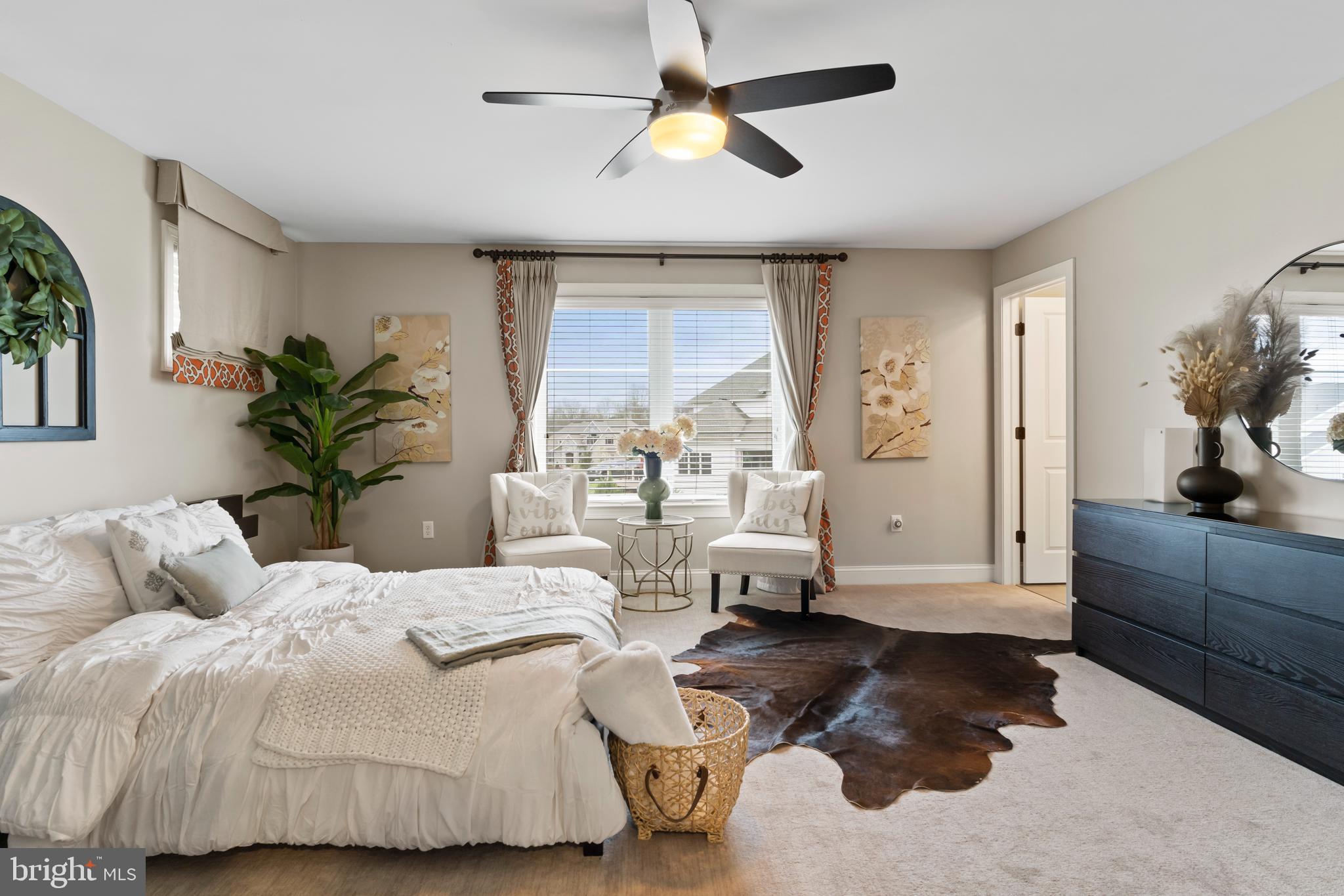 6522 Plowman Ridge Harrisburg, PA 17112 - Photo 80 of 117 a bedroom with a large bed and a chandelier fan