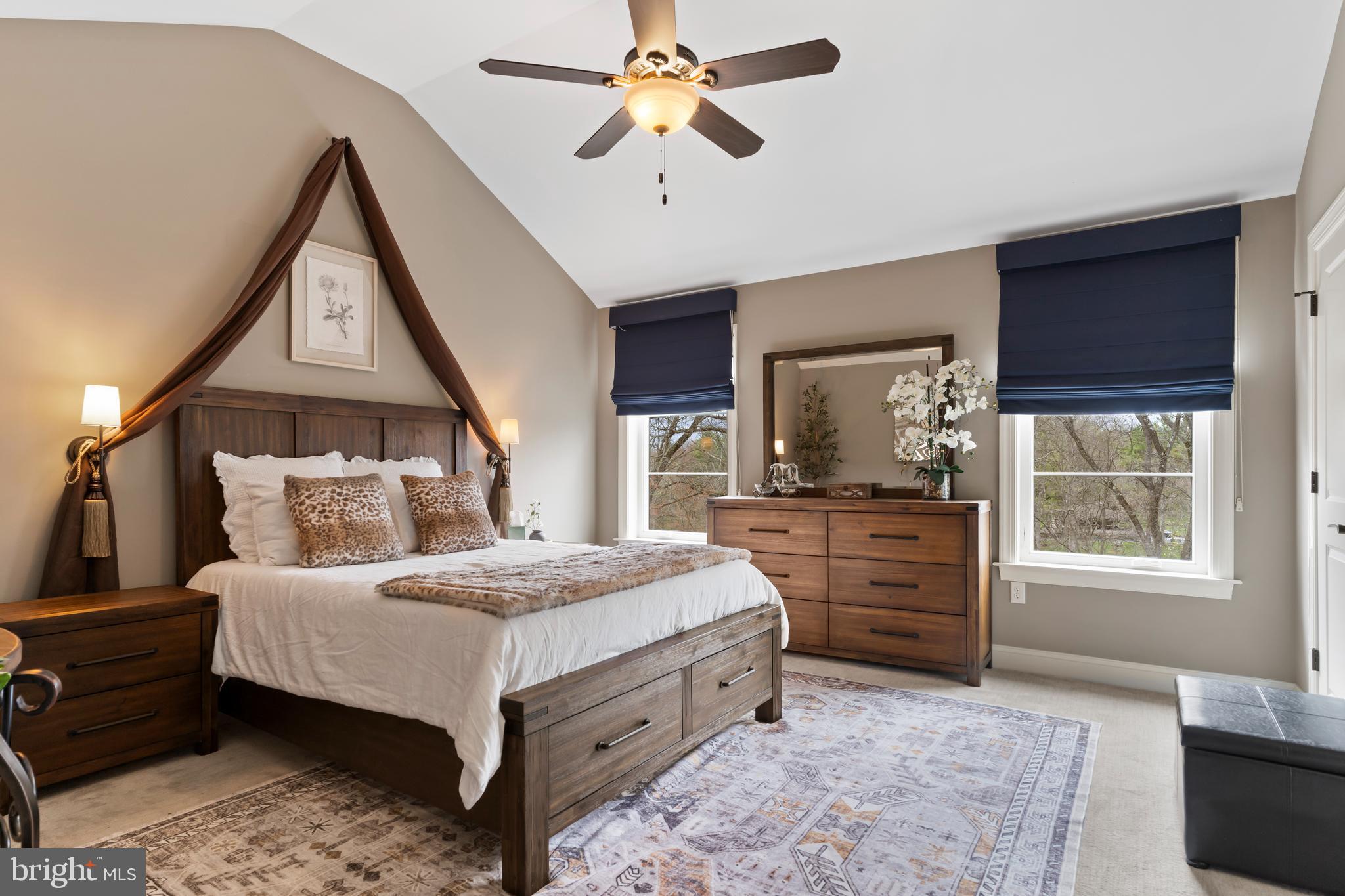 6522 Plowman Ridge Harrisburg, PA 17112 - Photo 89 of 117 a bedroom with a large bed a chandelier and dresser