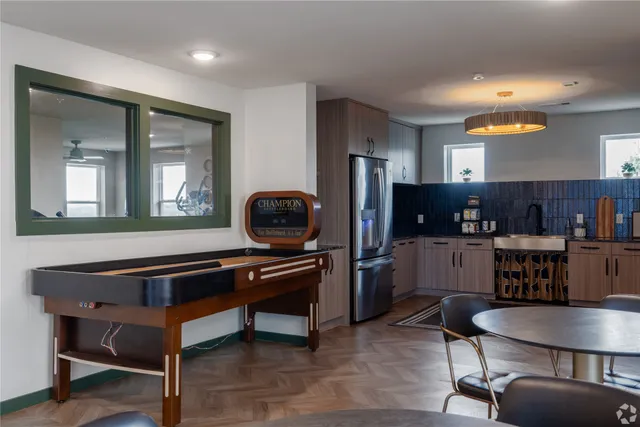 a living room with furniture a piano and a flat screen tv