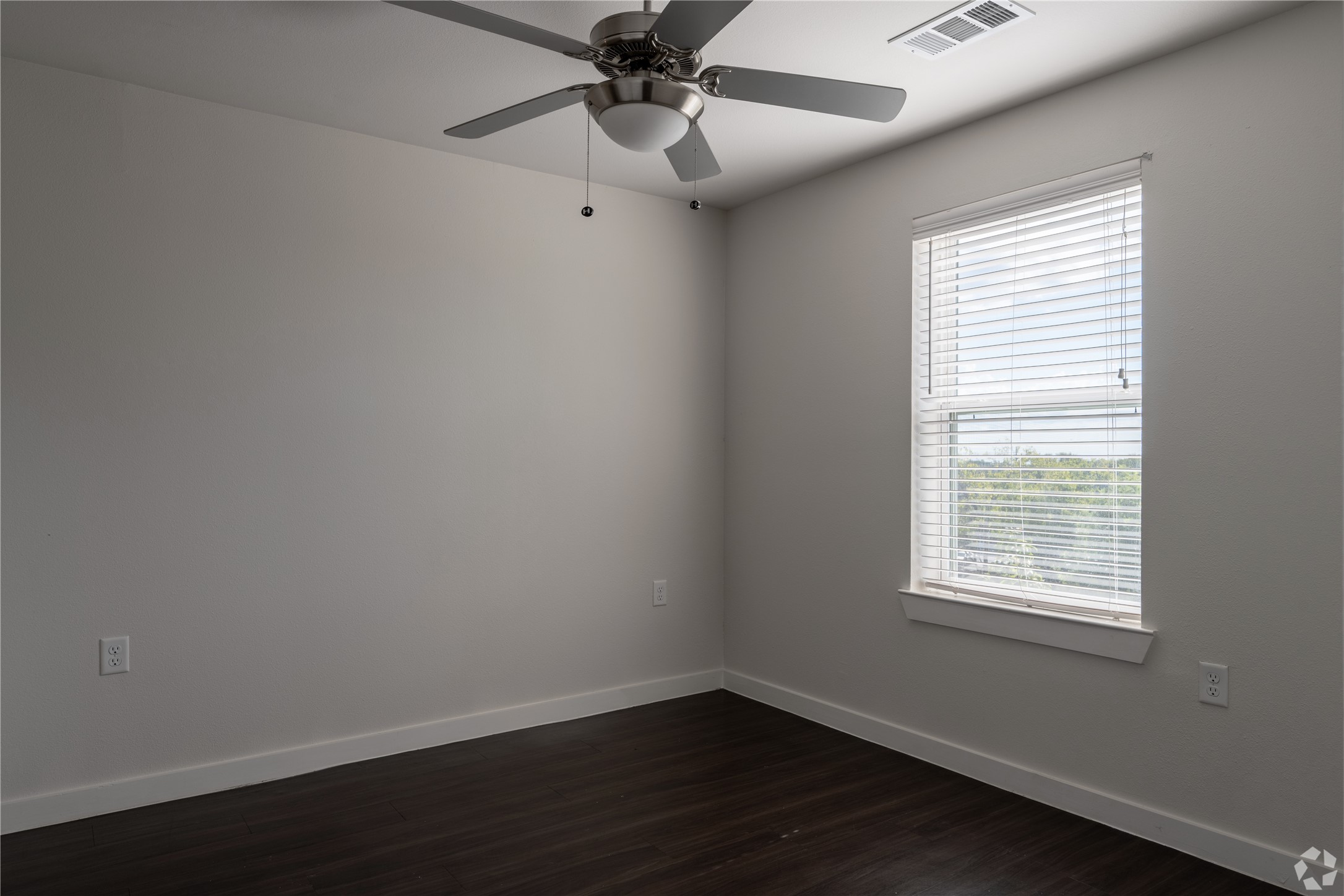 2401 East Oltorf Street, Unit 170 Austin, TX 78741 - Photo 3 of 14 a view of an empty room with wooden floor and a window