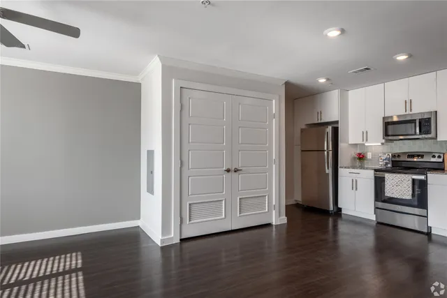 a view of kitchen with wooden floor and electronic appliances