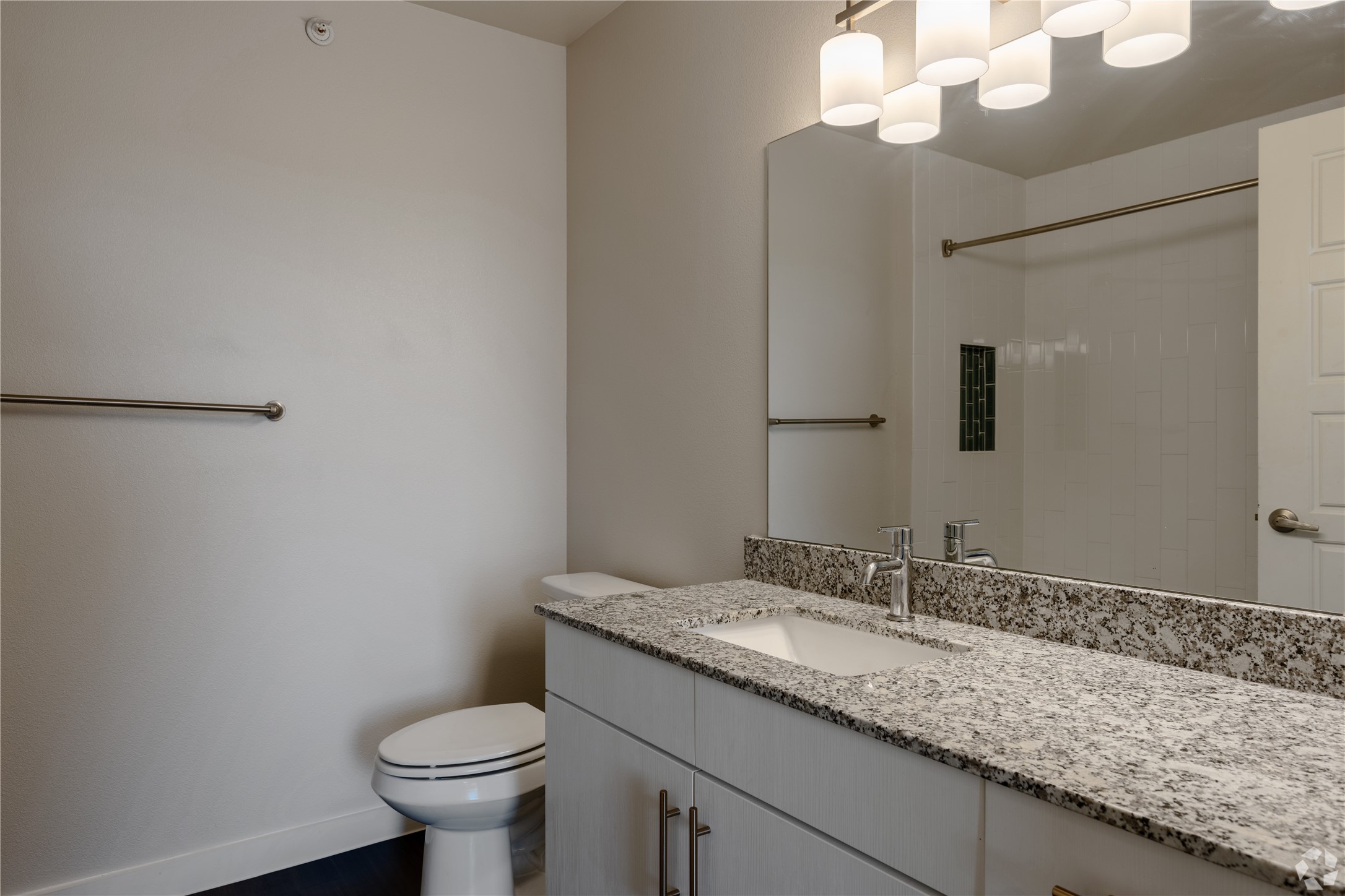 2401 East Oltorf Street, Unit 170 Austin, TX 78741 - Photo 7 of 14 a bathroom with a granite countertop sink a toilet and a mirror