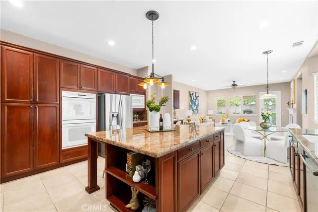 a kitchen with a sink stove and chairs