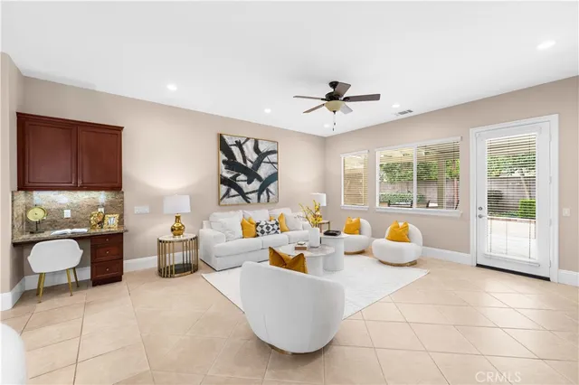 a living room with furniture and chandelier