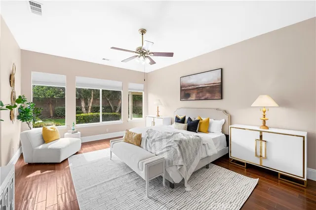 a bedroom with a large bed couch and a window