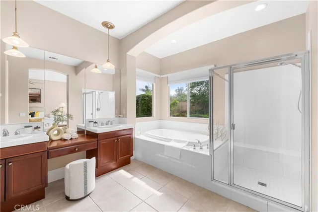 a bathroom with a tub sink shower and mirror
