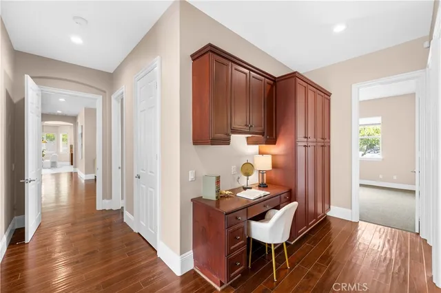 a hallway with furniture and wooden floor