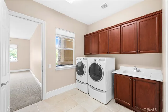 a utility room with sink dryer and washer