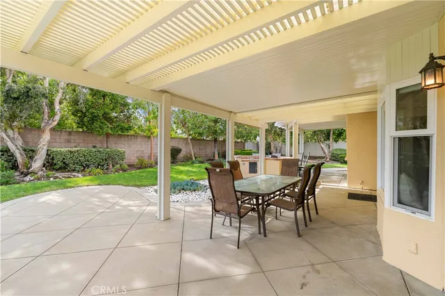 a dining room with furniture and garden view