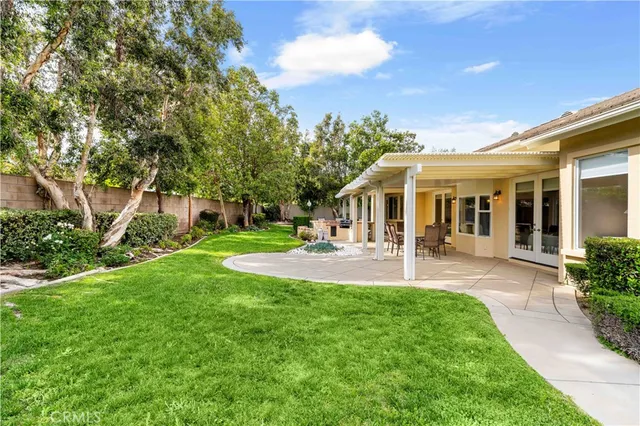 a front view of a house with yard patio and green space