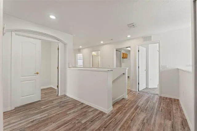 a view of a hallway with wooden floor