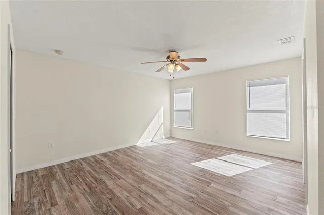 wooden floor in an empty room with a window