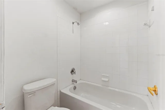 a white bath tub sitting next to a white toilet