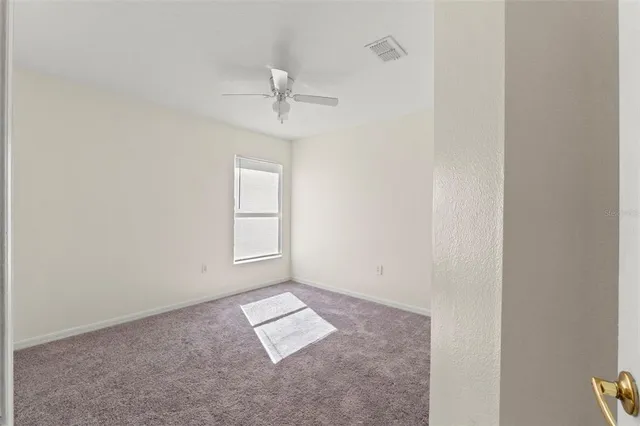 an empty room with windows and cabinet